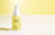 C ME - Vitamin C Serum by FRÉ - on a gel like surface with yellow background